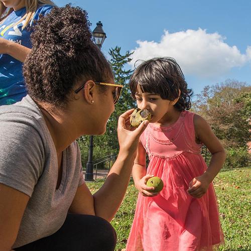 Ohio University students explore nature with a child