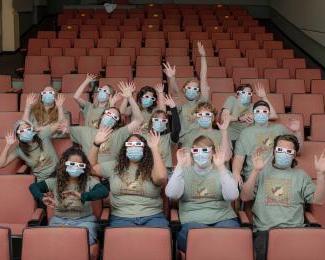 Students sitting in theater seats